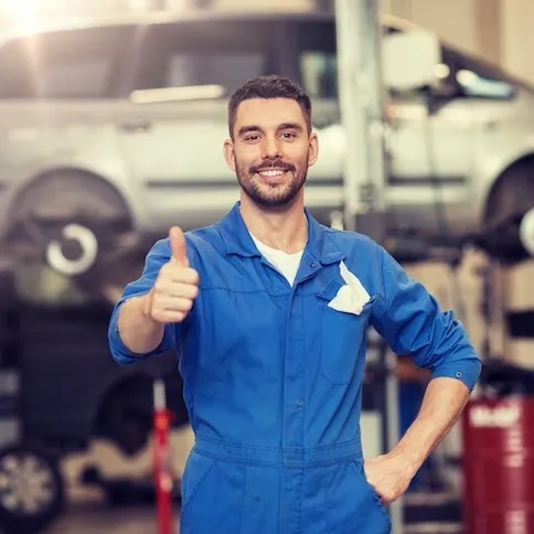 Mechanic at a local auto repair shop fixing a car